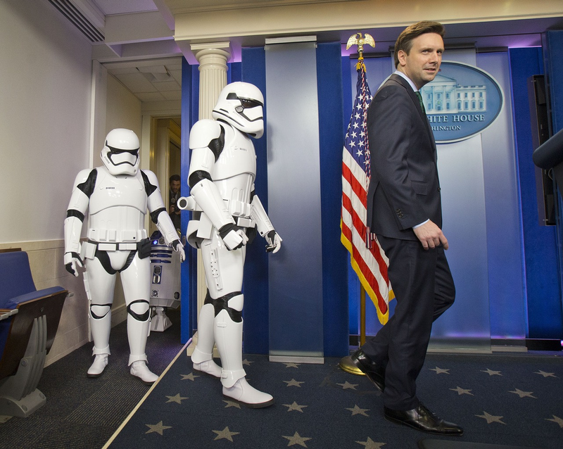 White House Press secretary Josh Earnest with stormtroopers and R2-DR at a press conference in December (Associated Press)
